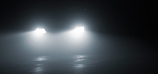 headlights of a car approaching in the dark